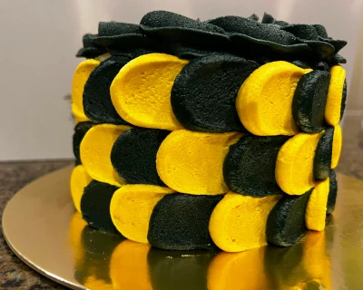 'One cool dude' black and yellow checkered smash cake