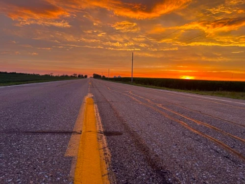 Iowa road with fields and sunset