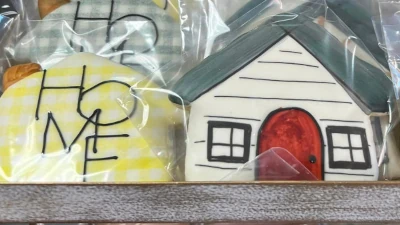 Single packaged cookies, neatly placed on a older wooden sales rack.